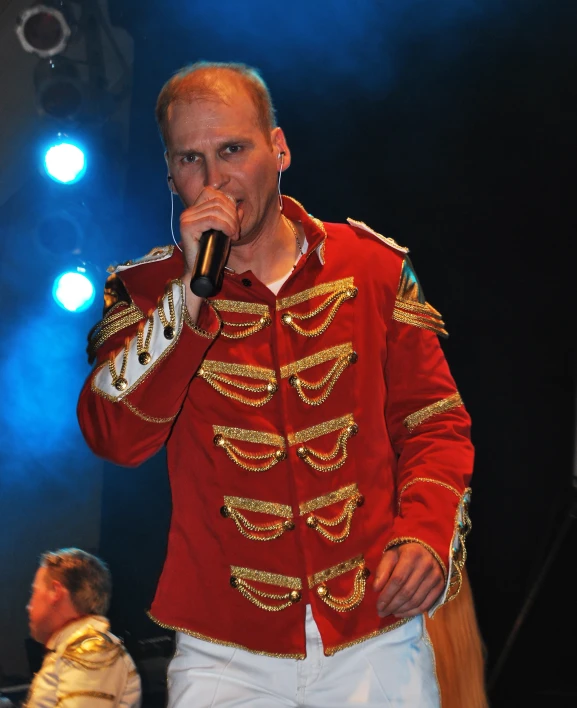 a man in a uniform holding a microphone