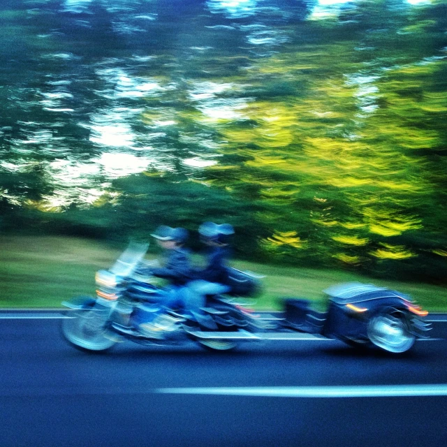 two people are riding on a motor bike