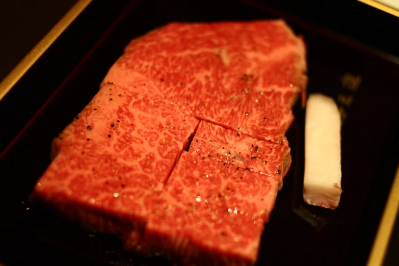 steak and a knife sit on a serving tray