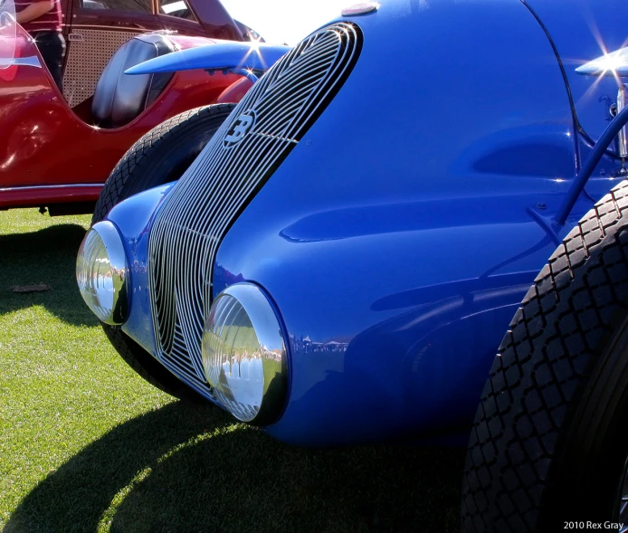 classic cars parked in a row on the grass