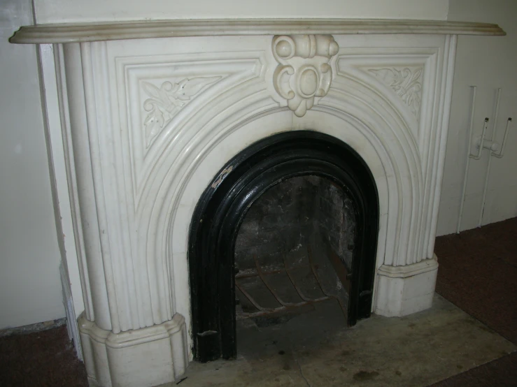 a fireplace with white painted design on it