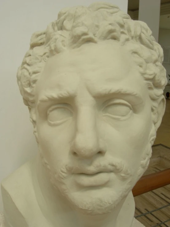 a white plaster bust of a man's face