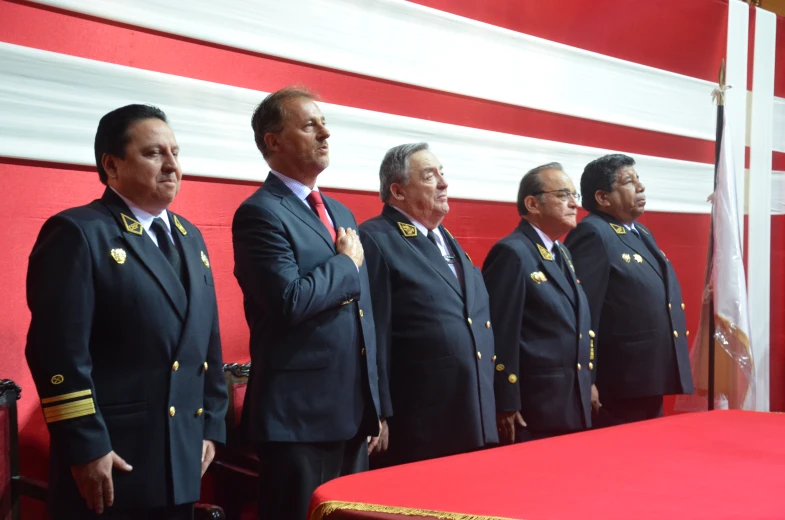 several men standing on red platform in uniform