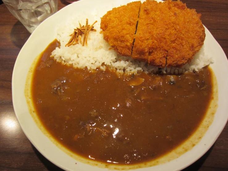 a plate with rice, sauce and curry