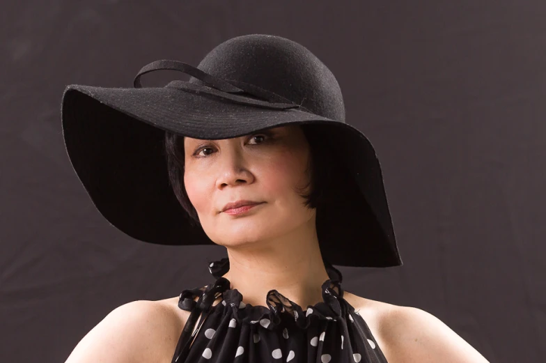 woman wearing black and white hat and black dress