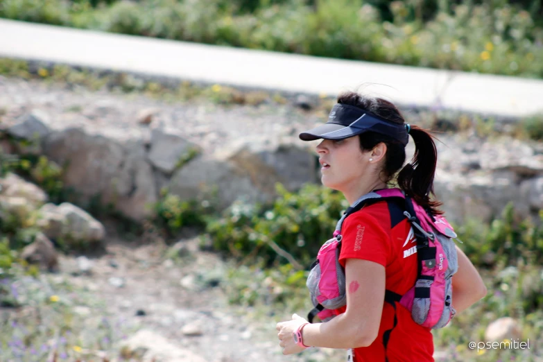 the  with the red backpack has a thumbs up