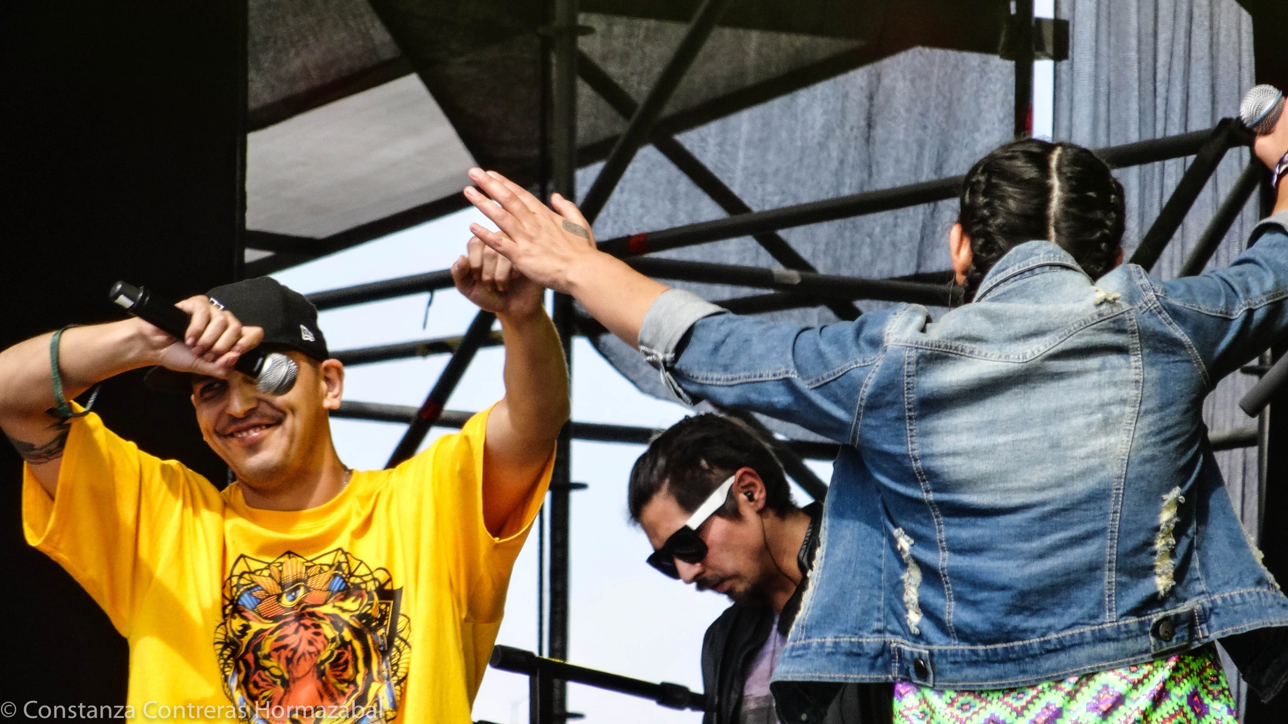 people standing around in front of a concert tent