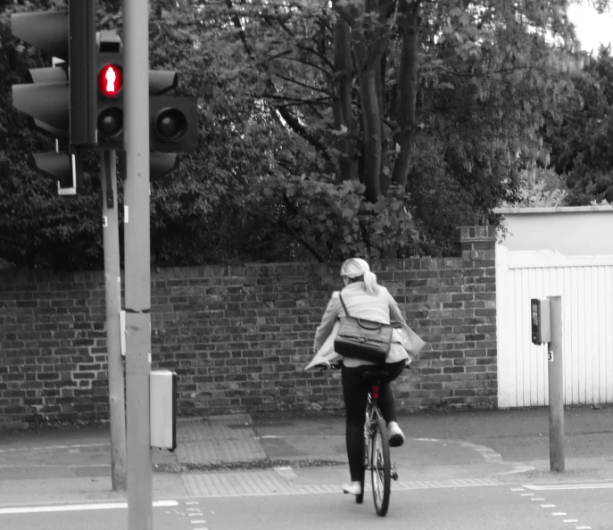 a person on a bike is at a red traffic light