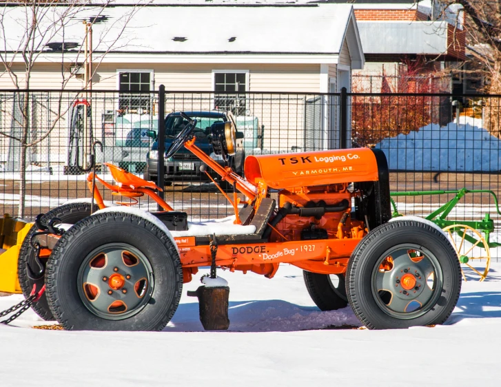 a small machine is in the snow near a tree