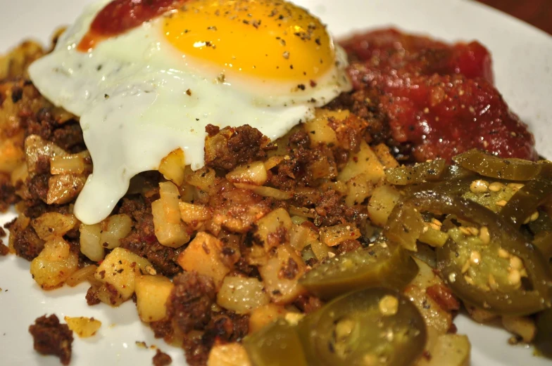 a dish on a plate, with eggs and vegetables