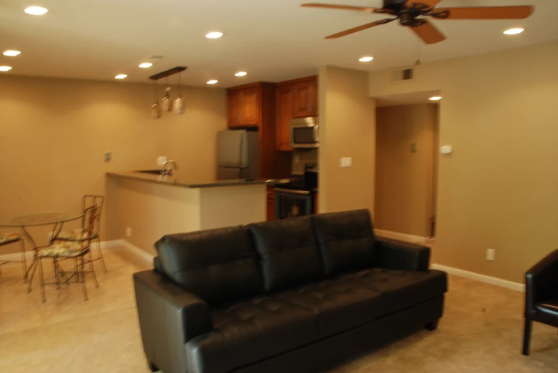 the black couch in the large open floor plan