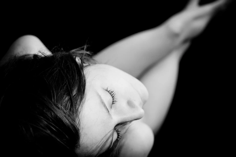 a girl with her eyes closed in a black and white po