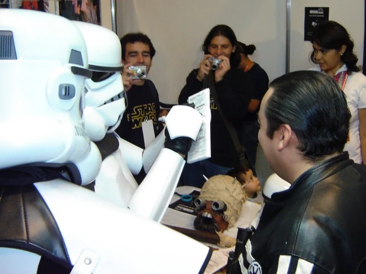 group of people taking pictures of stormtroot helmets