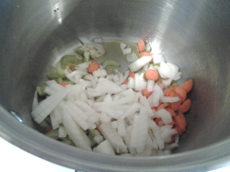 some chopped up carrots and onions in a large bowl