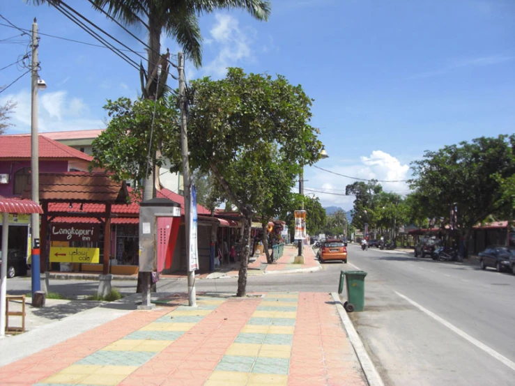 street with shops and trees lined in both directions