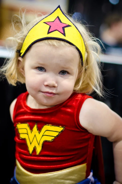 a little girl in costume looking at the camera