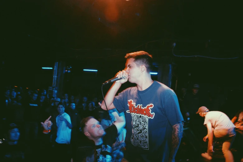 a man singing into a microphone at a concert