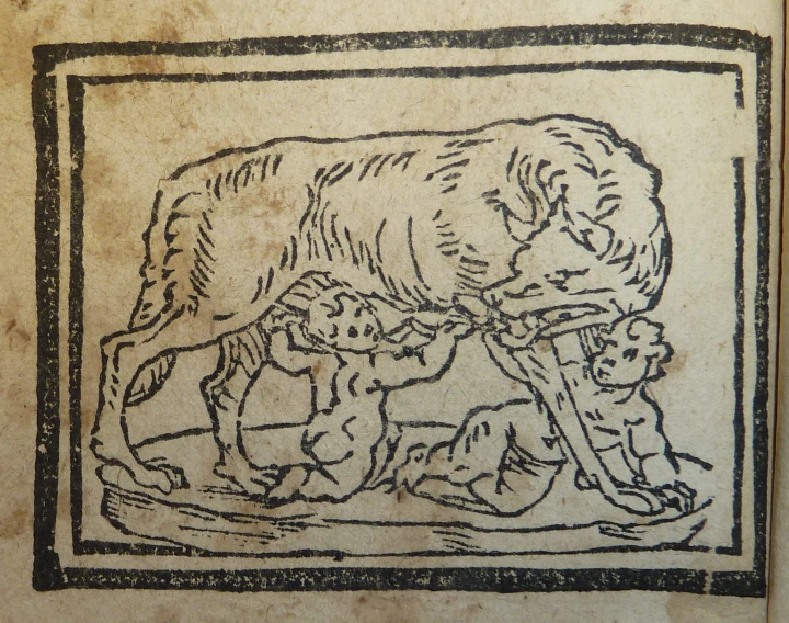 an old book with a drawing of a horse and dogs