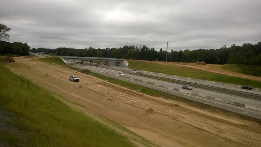 a freeway with several lanes and three cars on one