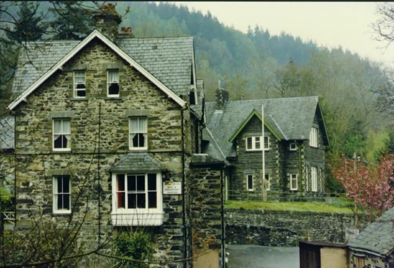 a stone house is shown with windows and balconies