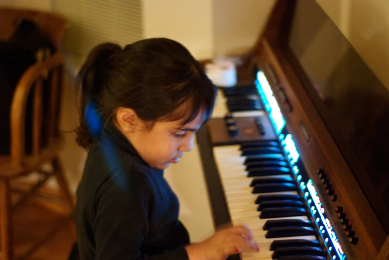 the little girl is playing the pipe organ