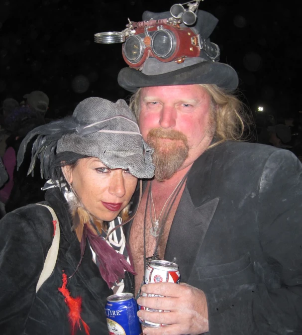 a man and woman dressed as pirates pose with beers