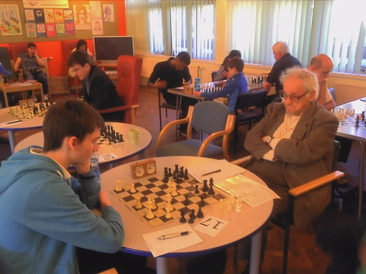 people sitting at a table playing chess