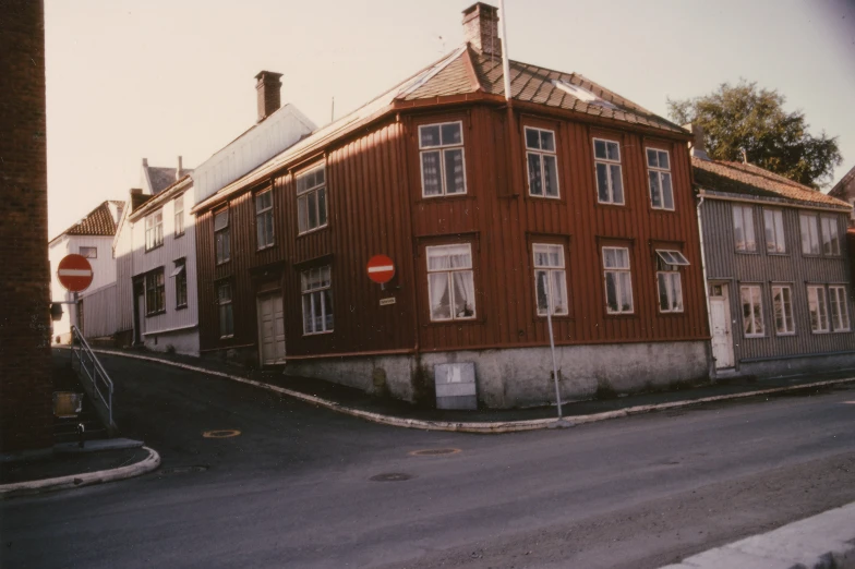 a large red building next to a traffic sign