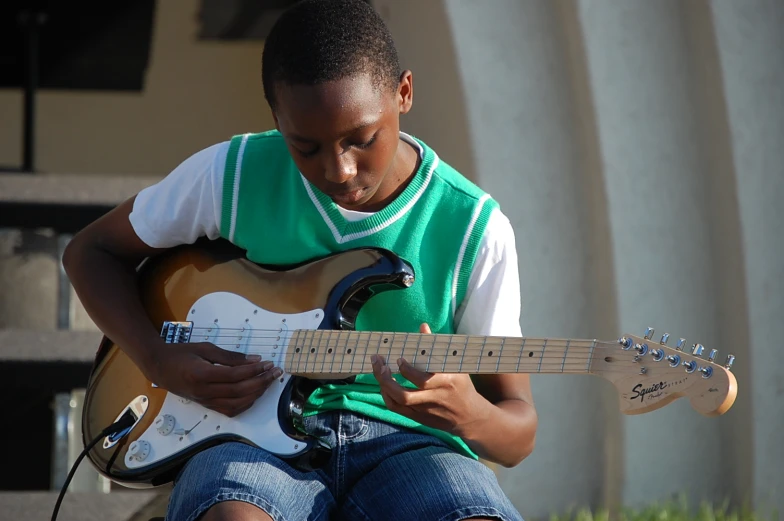 a person with an electric guitar on a street