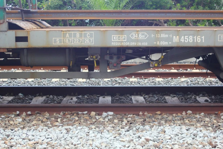 an area of tracks with two rail car cars underneath it
