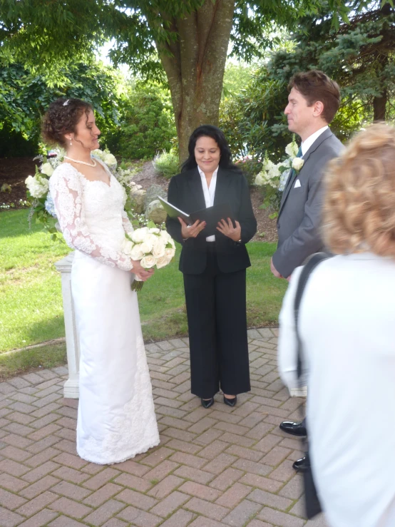 a couple standing in front of each other on a brick walkway