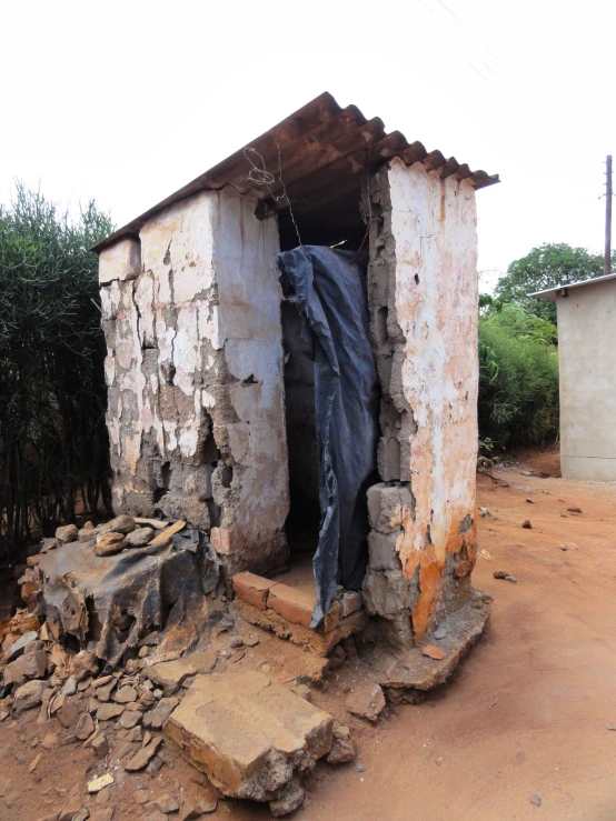 a broken building with a garment on the outside