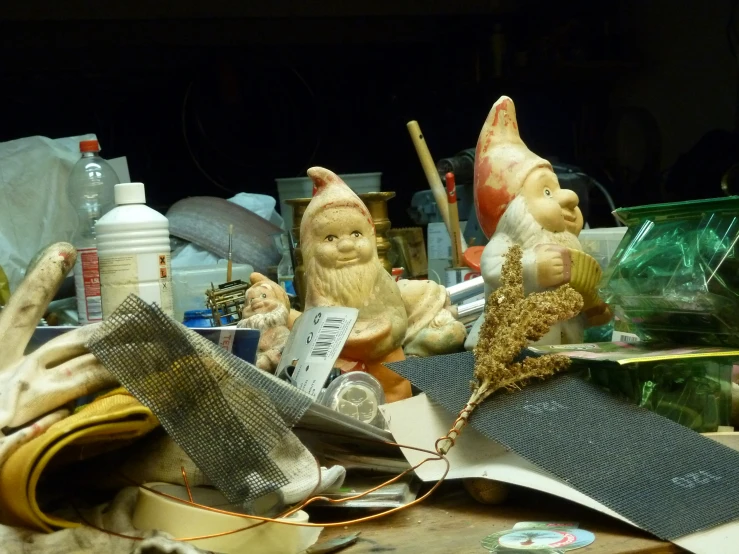 several statues of gnomes sitting on a table top