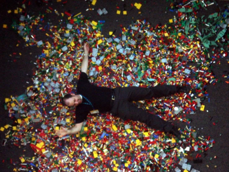 a person is laying down on a pile of legos