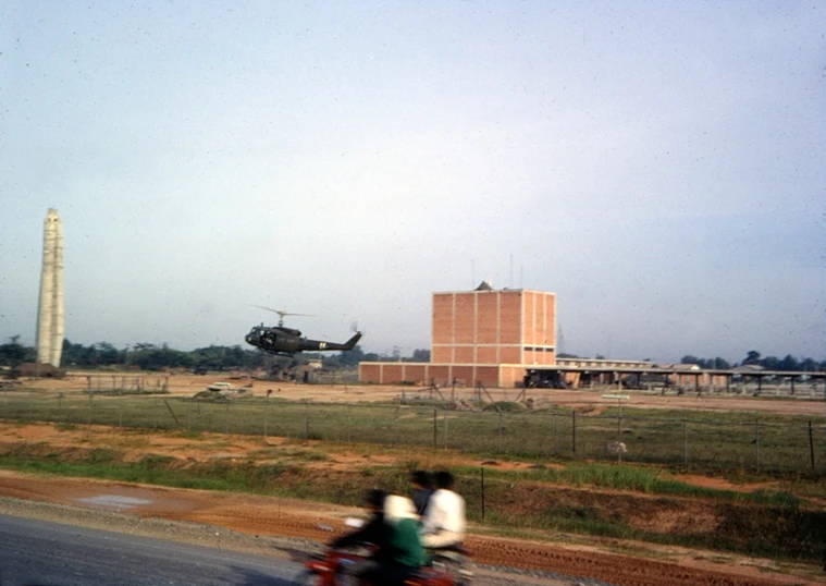 a man is on his motorcycle watching a helicopter