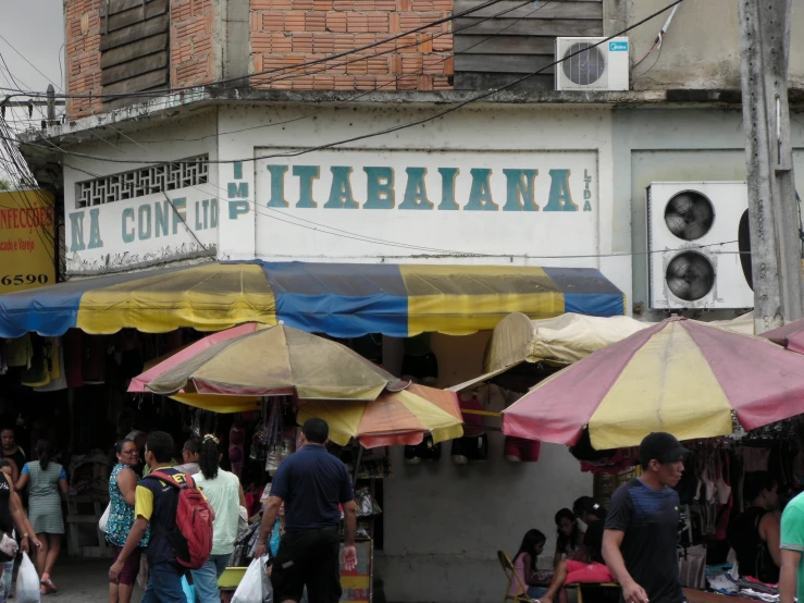 the people walk on the street behind two umbrellas