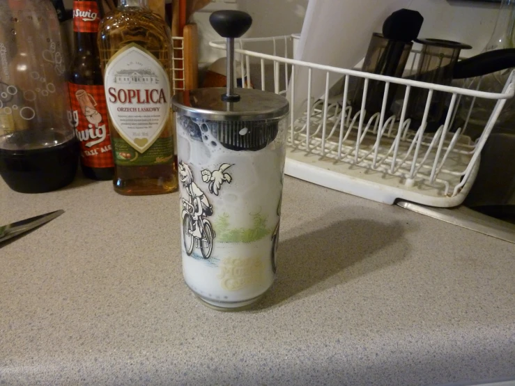 a small canister with beer on a counter
