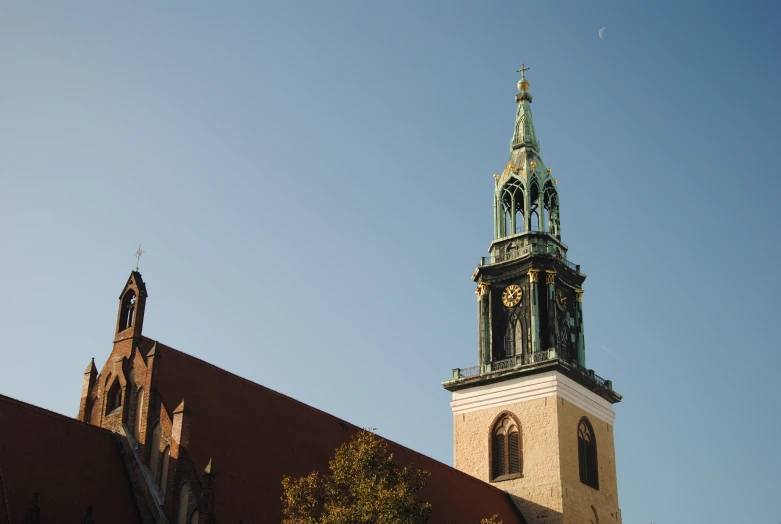 a tall steeple that has a clock on it