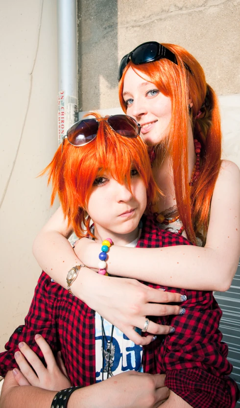 a couple of red haired girls cuddling and smiling