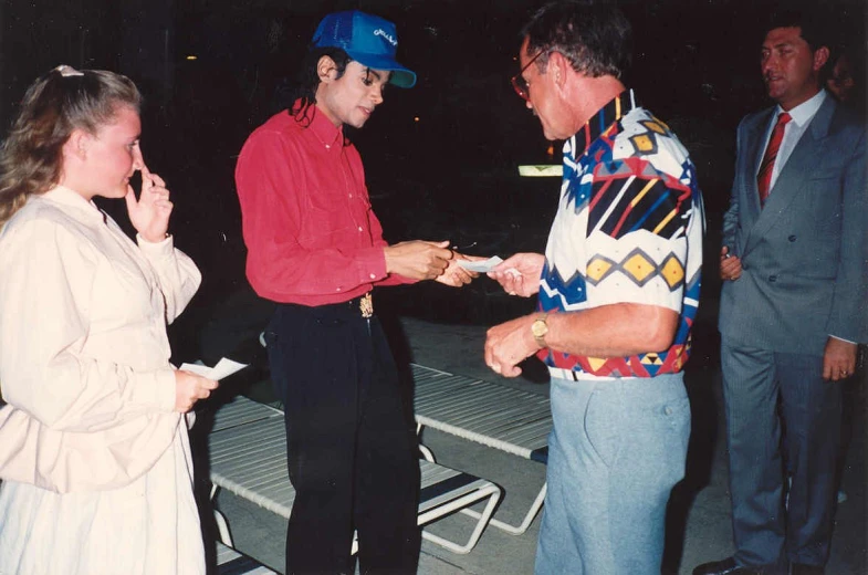 a couple of people standing around and exchanging coins