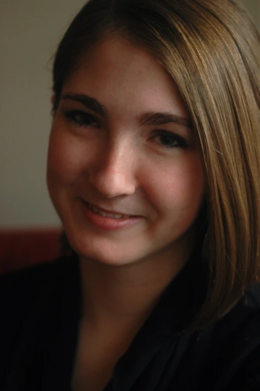 a woman with long blonde hair smiling and wearing a tie