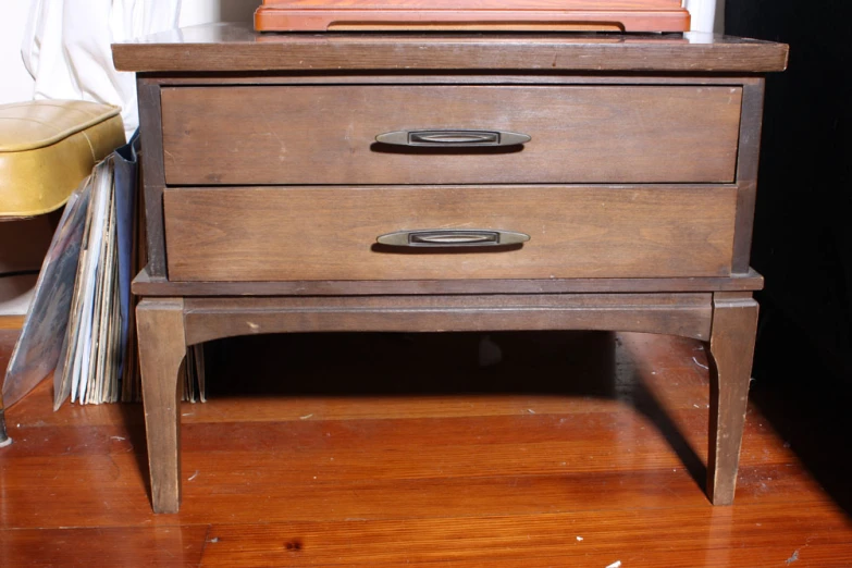 a drawer that has papers and some books on top