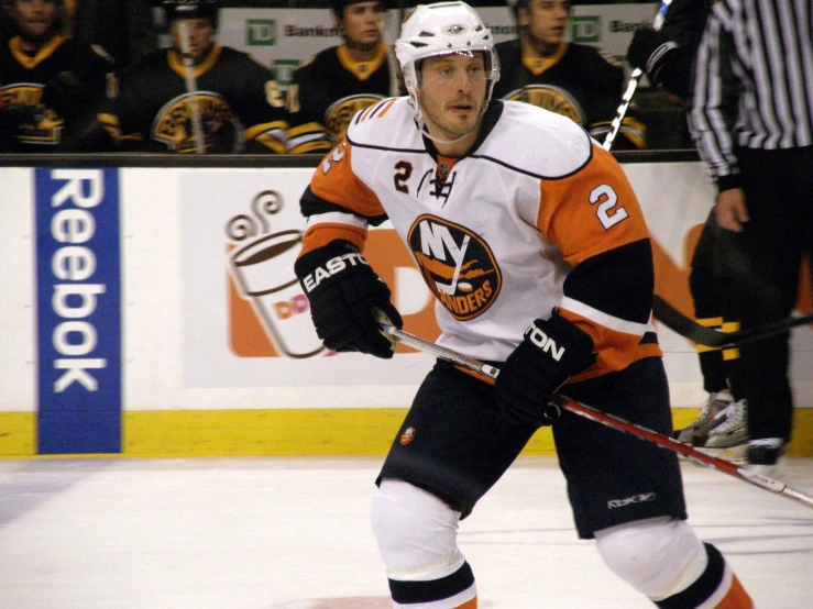 a hockey player on the ice in front of a group