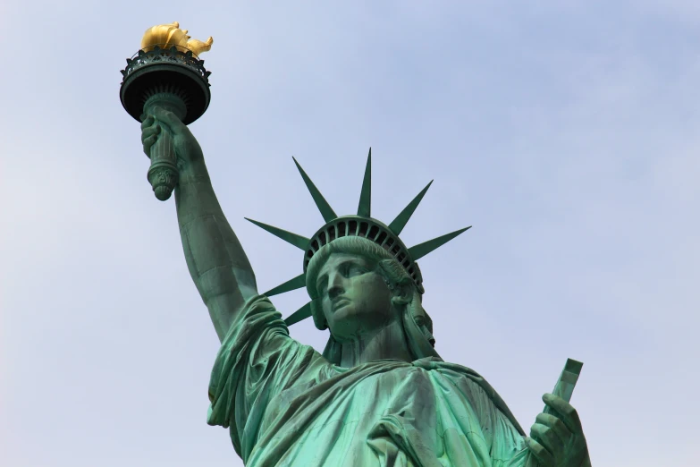 the statue of liberty is shown with two golden cup holders