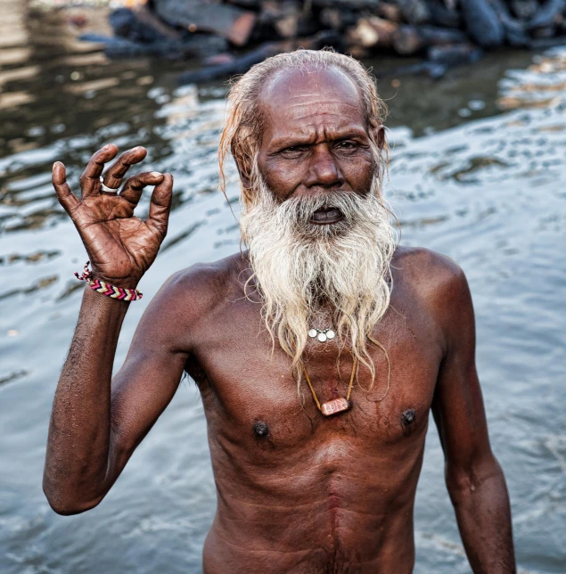 an old man with a long white beard is standing in the water