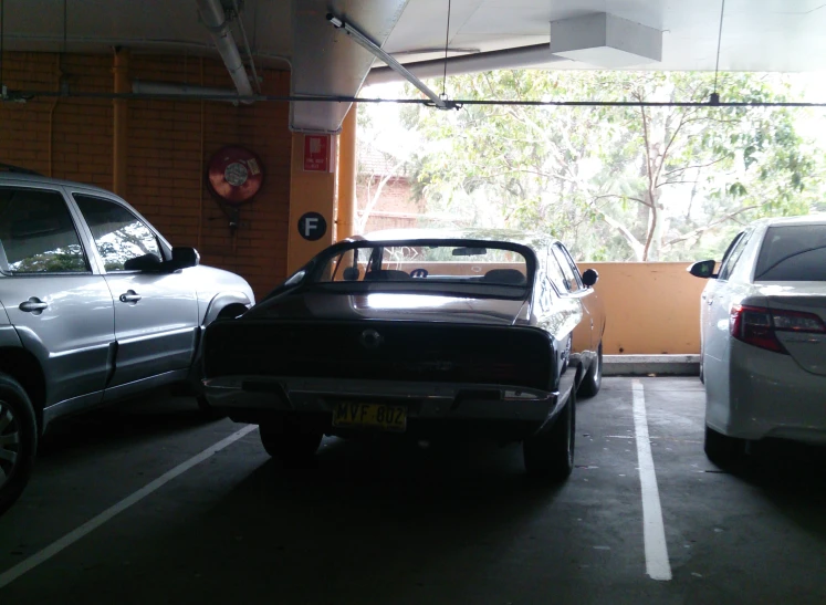 two cars parked in a parking lot with the door open