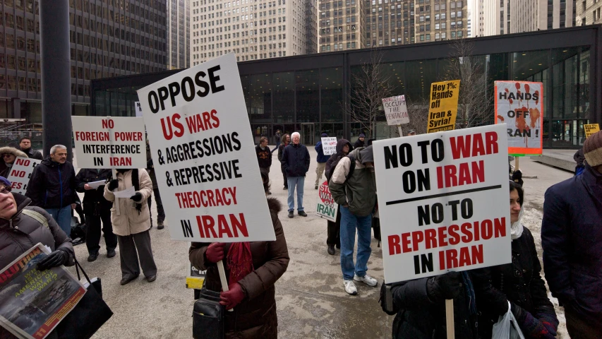 people march on the streets carrying protest signs