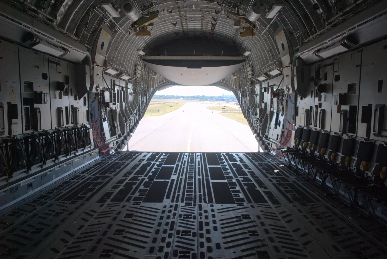 an airplane with its door open and the runway in view