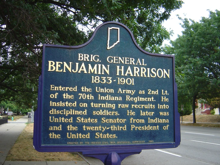 a historical marker at the intersection of a roadway