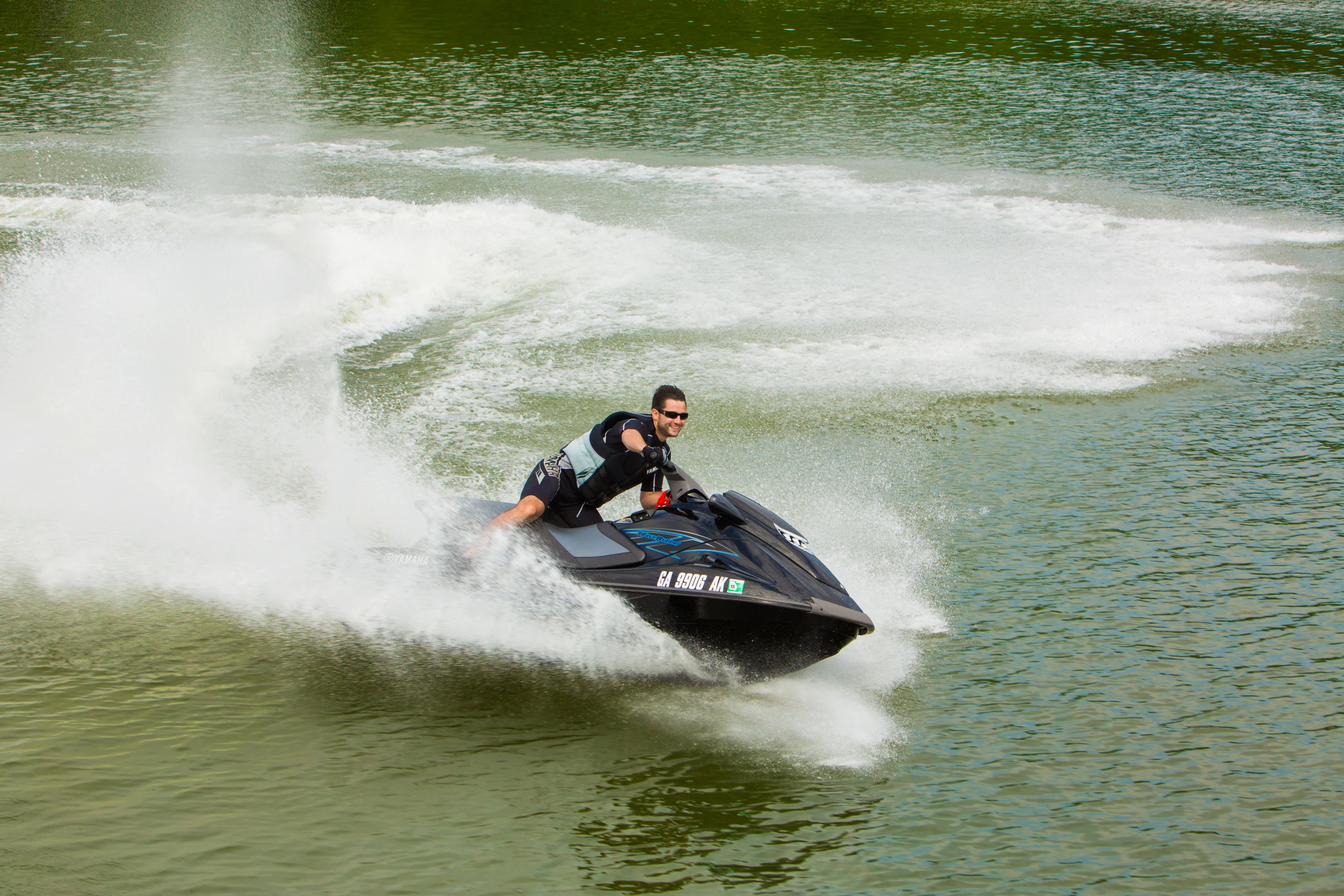 a man on a jet ski with water in the background